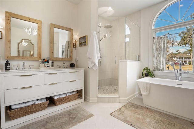 bathroom featuring vanity, tile patterned floors, and plus walk in shower