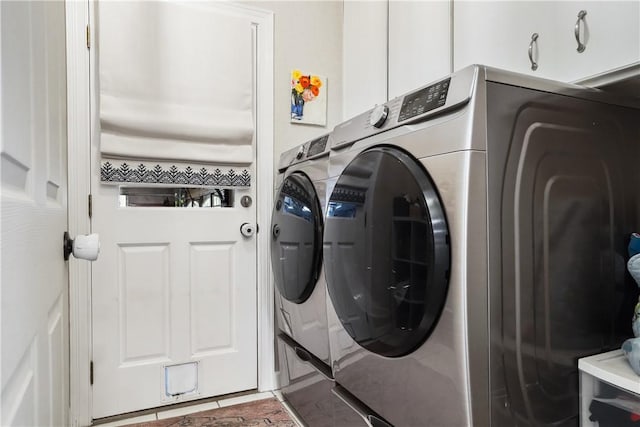 clothes washing area featuring cabinets, separate washer and dryer, and tile patterned flooring