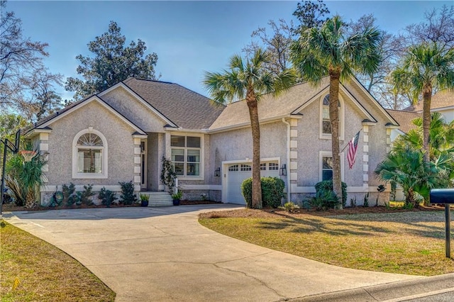 view of front of home featuring a garage and a front lawn