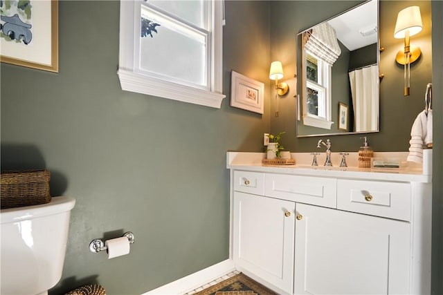 bathroom featuring vanity and toilet