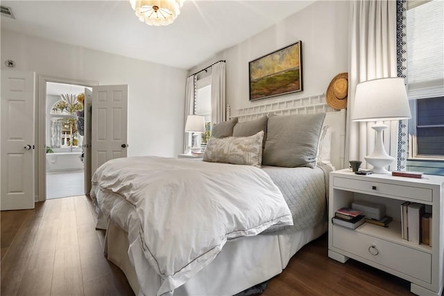 bedroom with dark hardwood / wood-style floors