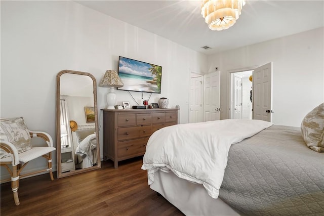 bedroom with dark hardwood / wood-style flooring