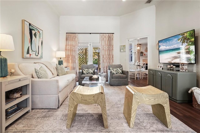 living room with hardwood / wood-style floors and ornamental molding