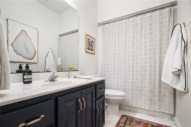 bathroom with vanity, tile patterned floors, and toilet