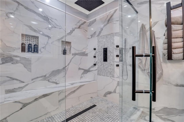 bathroom featuring a shower with door