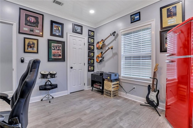 office featuring light wood-type flooring and ornamental molding