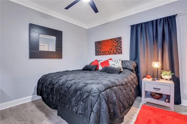 bedroom with ceiling fan, crown molding, and wood-type flooring