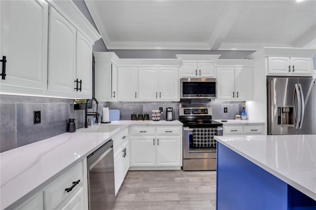 kitchen featuring white cabinets, light stone countertops, appliances with stainless steel finishes, and tasteful backsplash