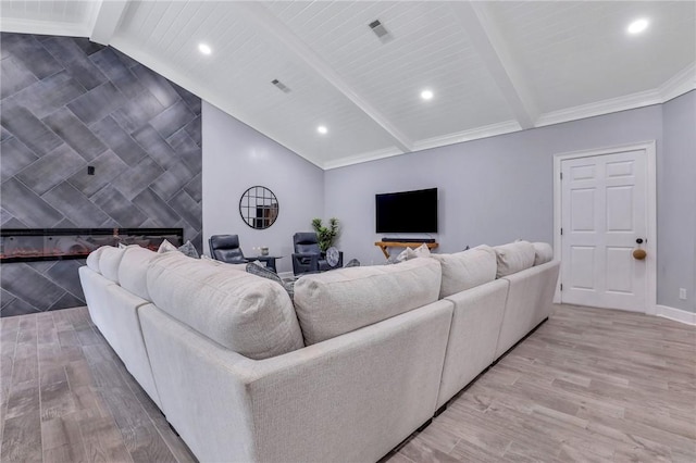 living room with vaulted ceiling with beams, light wood-type flooring, a fireplace, and tile walls