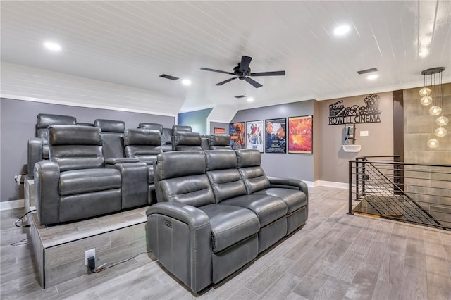 home theater with ceiling fan and light hardwood / wood-style flooring