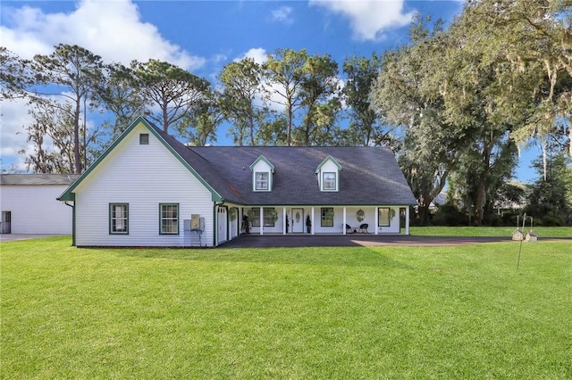 cape cod-style house with covered porch and a front lawn