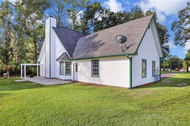 back of house featuring a patio area and a lawn