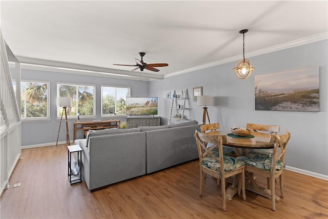 dining area featuring hardwood / wood-style flooring, ceiling fan, and ornamental molding