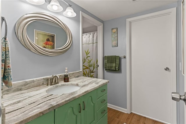 bathroom with hardwood / wood-style flooring and vanity