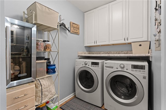 washroom featuring cabinets and washing machine and dryer