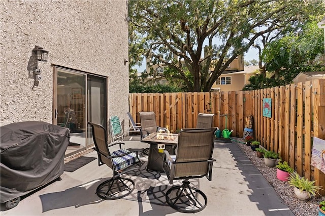 view of patio with a fire pit and grilling area