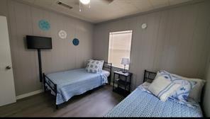 bedroom featuring ceiling fan and dark hardwood / wood-style flooring