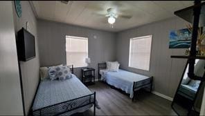 bedroom featuring multiple windows, ceiling fan, and hardwood / wood-style flooring