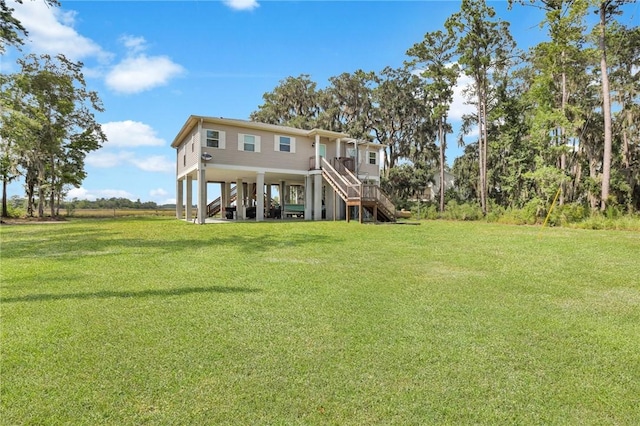 back of house with a carport and a lawn