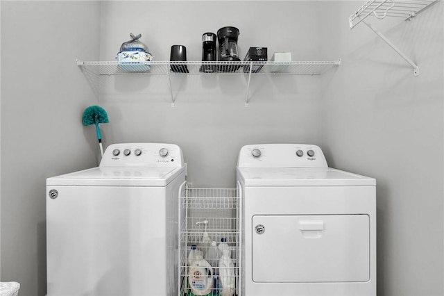 clothes washing area featuring washer and dryer