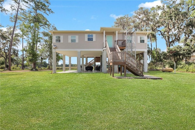 rear view of property featuring a lawn and a carport