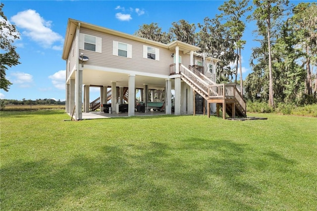 rear view of house with a lawn and a carport