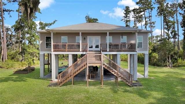 back of house with french doors and a yard