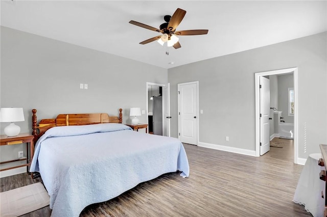 bedroom featuring hardwood / wood-style flooring, ceiling fan, and ensuite bath