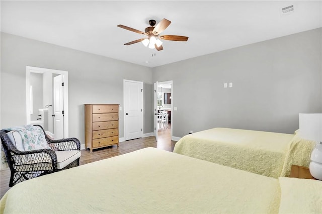 bedroom with connected bathroom, ceiling fan, and wood-type flooring