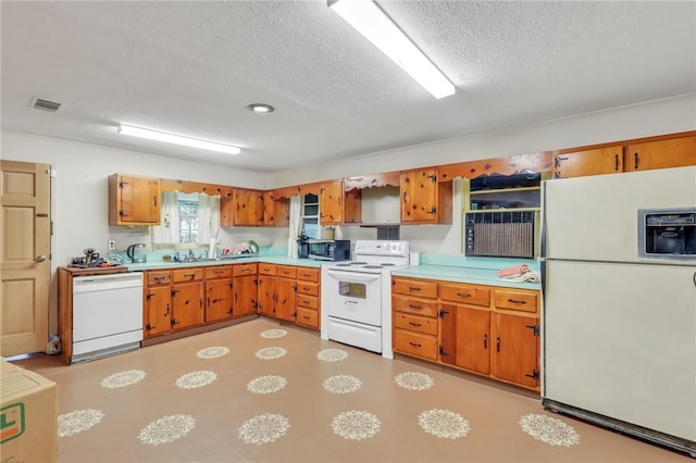 kitchen with white appliances and a textured ceiling