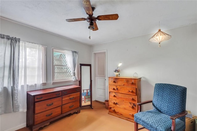 sitting room featuring light colored carpet and ceiling fan