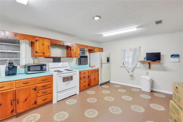 kitchen with a textured ceiling and white appliances