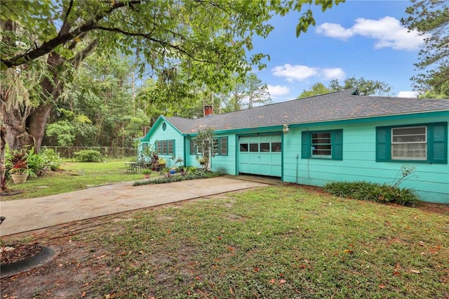 single story home featuring a garage and a front lawn