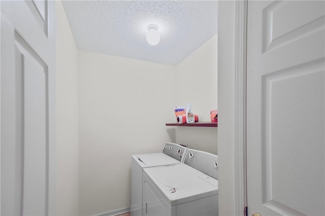 clothes washing area featuring a textured ceiling and independent washer and dryer