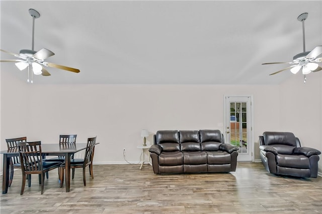 living room featuring ceiling fan and light wood-type flooring