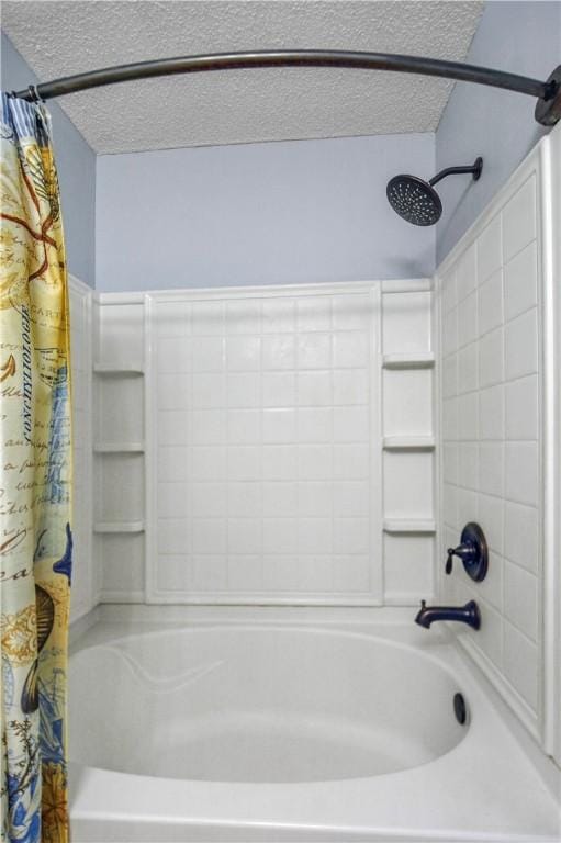 bathroom featuring shower / bath combo and a textured ceiling