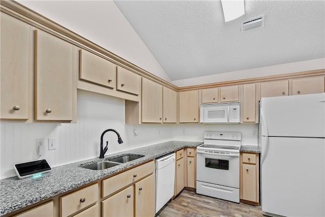 kitchen with white appliances, sink, light hardwood / wood-style flooring, light stone counters, and lofted ceiling