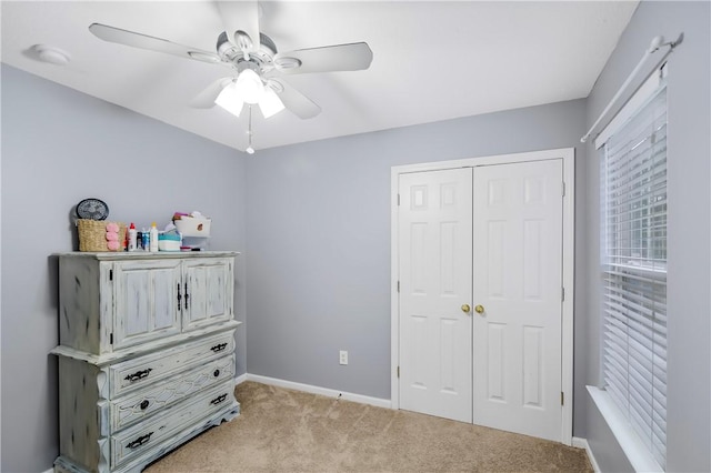 carpeted bedroom featuring a closet and ceiling fan