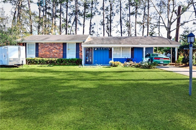 ranch-style house featuring a carport and a front yard