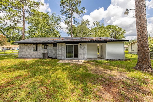 158 Yorktown Dr, Brunswick, GA 31525 - rear view of house featuring a lawn and central AC unit