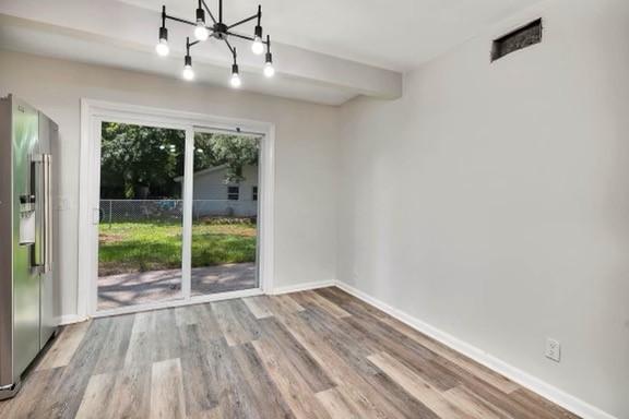 158 Yorktown Dr, Brunswick, GA 31525 - interior space with beamed ceiling, an inviting chandelier, and light hardwood / wood-style flooring