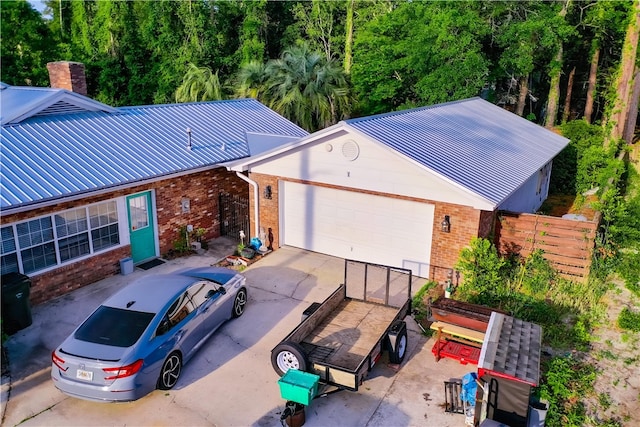 1622 Booth St, Waycross, GA 31501 - view of front facade featuring brick siding, metal roof, fence, and concrete driveway