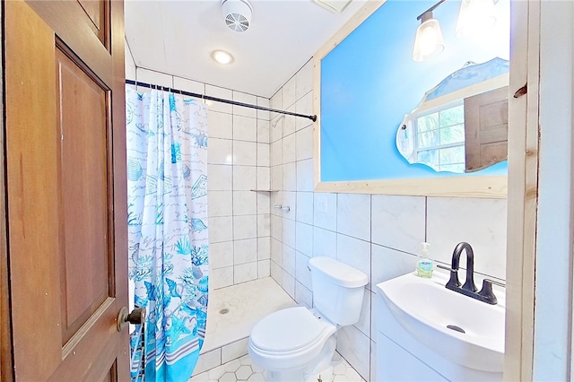 1622 Booth St, Waycross, GA 31501 - bathroom featuring a tile shower, toilet, tile walls, vanity, and tile patterned flooring