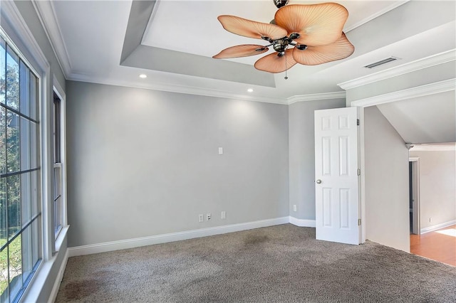 spare room featuring carpet flooring, ceiling fan, a healthy amount of sunlight, and ornamental molding