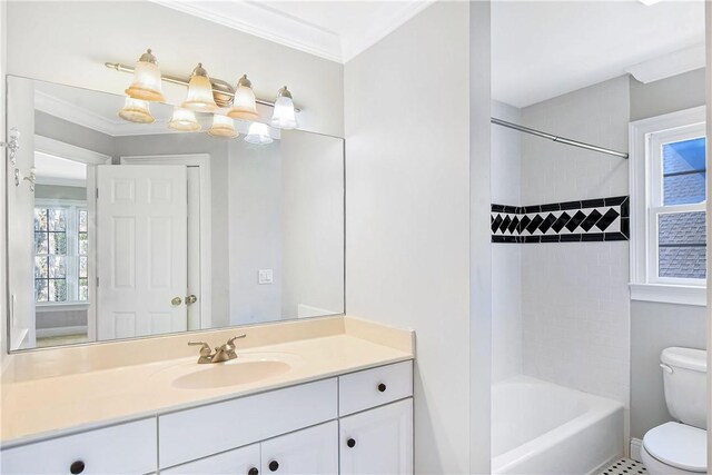 full bathroom featuring ornamental molding, tiled shower / bath combo, vanity, tile patterned flooring, and toilet