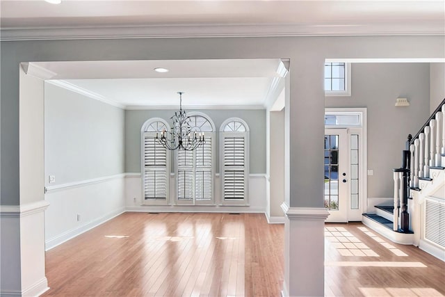 interior space featuring a chandelier, light hardwood / wood-style floors, and ornamental molding