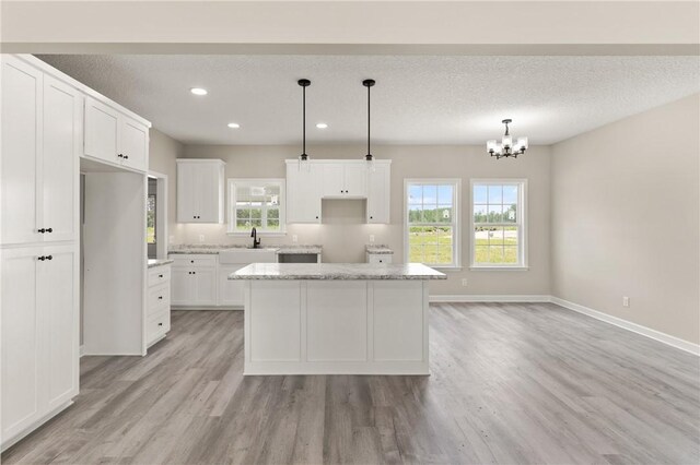 4432 Pembers Rd, Nahunta, GA 31553 - kitchen with light wood-style flooring, a kitchen island, white cabinets, and recessed lighting