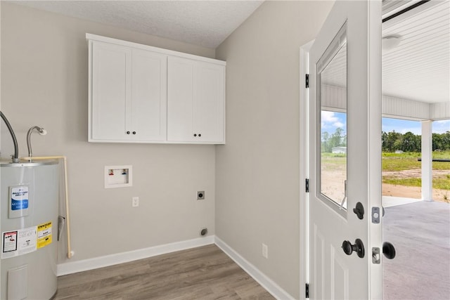 4432 Pembers Rd, Nahunta, GA 31553 - laundry area featuring electric water heater, cabinet space, hookup for an electric dryer, washer hookup, and wood finished floors