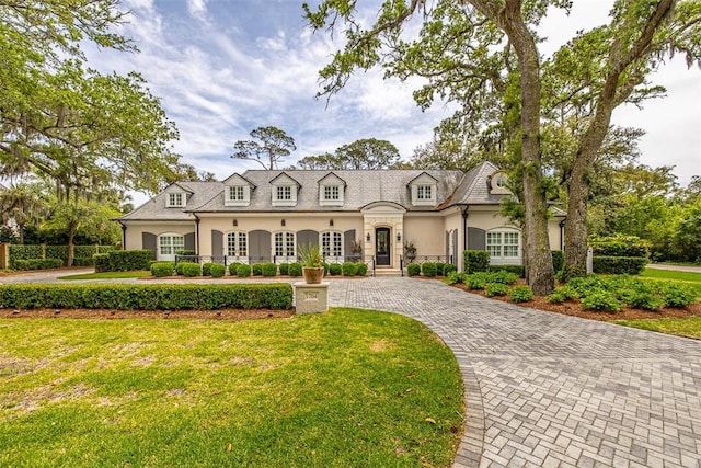 french country style house with a front lawn