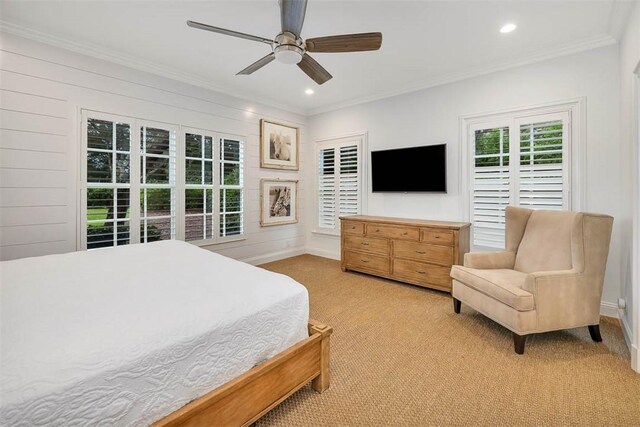 bedroom with ceiling fan, light colored carpet, and crown molding